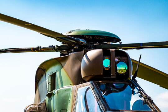 A close-up view of the main rotor of a military helicopter