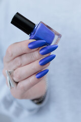 beautiful hand with long nails and blue manicure
