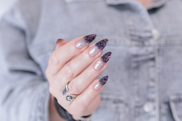 Female hands with long nails and white and black thermo french manicure