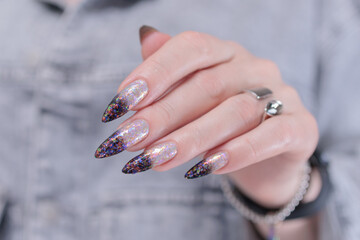 Female hands with long nails and white and black thermo french manicure