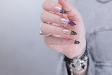 Female hands with long nails and white and black thermo french manicure