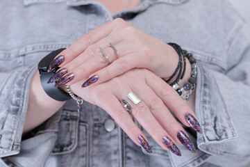 Female hands with long nails and black nail polish