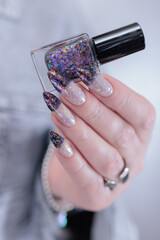 Female hands with long nails and white and black thermo french manicure