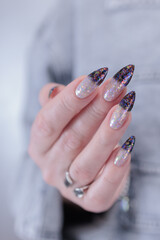 Female hands with long nails and white and black thermo french manicure	