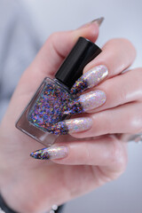 Female hands with long nails and white and black thermo french manicure	