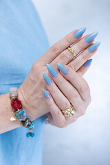 beautiful hand with long nails and light baby blue manicure	