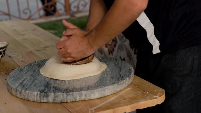 People making bread in tandoor oven in Khiva