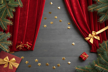 Velvet red stage curtains and a backdrop adorned with golden ribbons and stars. Luxury. Event. Party. Sophistication.