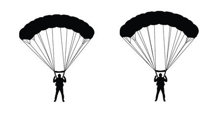 Two silhouetted skydivers descending with open parachutes in the sky