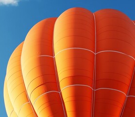  Soaring Dreams: A vibrant hot air balloon ascends towards the clear blue sky, a symbol of freedom, adventure, and the pursuit of dreams.