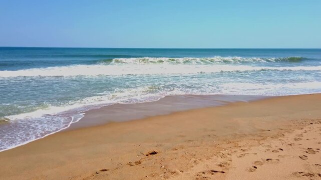 Beautiful view waves crashing on the sand