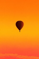 Fototapeta premium Hot air balloon floating against a vibrant sunset sky over a tranquil landscape