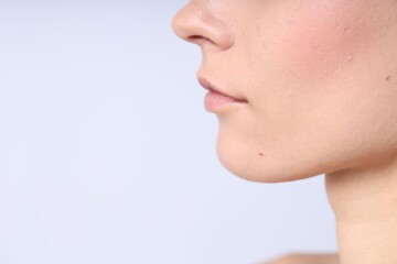 Obraz premium Woman with normal skin on light background, closeup. Space for text