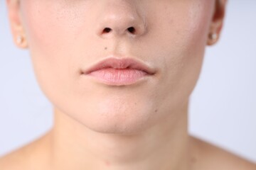 Obraz premium Woman with normal skin on light background, closeup