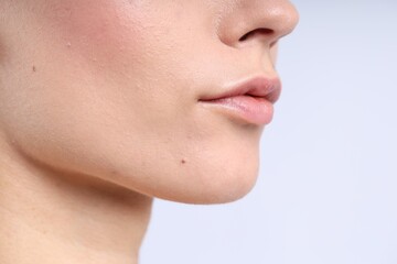 Obraz premium Woman with normal skin on light background, closeup. Space for text