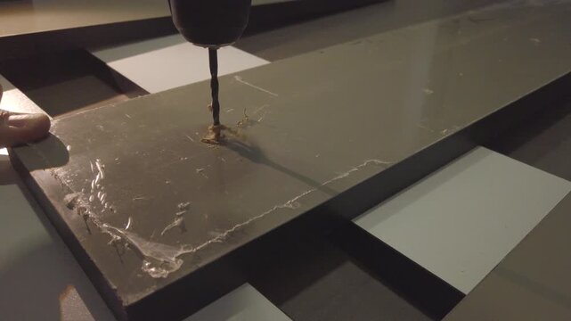 Hand drill making hole in an mdf board. DIY home project