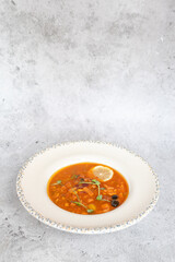 Traditional Georgian bean soup Lobio with herbs in ceramic plate
