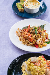 Spicy spaghetti with shrimps in tomato sauce close-up on a plate.