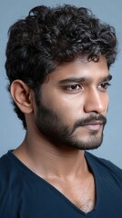 Obraz premium Smiling young man with curly hair stands confidently with arms crossed in front of a presentation board filled with sketches and notes
