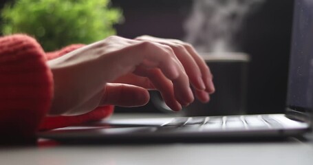 Close up of freelancer's developer hands typing program code on laptop keyboard in coworking. Businessman at work in working in cafe. Copywriter writing text on computer keyboard in coffee shop.