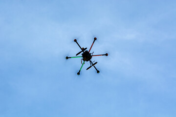 Drone flying in a blue sky