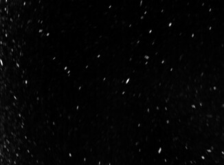 Minimal blurred snow overlay on dark, black background. Subtle motion particle texture ideal for adding gentle winter mood. Good to use as photo overlay. Snowfall. Abstract unfocused background