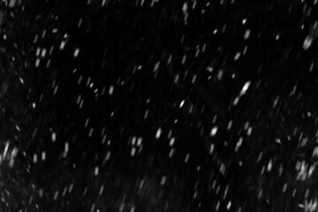 Snowfall overlay with soft blurred particles on black background. Falling snow isolated on dark background. Layer to overlay and blend snowfall into your photo project. For photo edit. Photo Effect