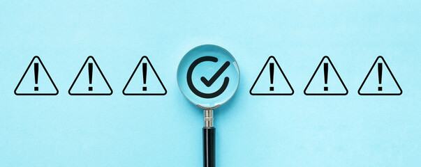 A magnifying glass is placed over a row of red and black triangles