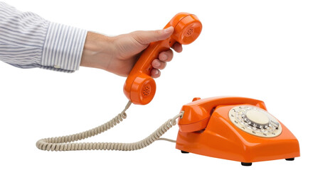 Isolated Orange rotary dial telephone, vintage desk phone with coiled cord, hand holding receiver