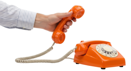Isolated Orange rotary dial telephone, vintage desk phone with coiled cord, hand holding receiver