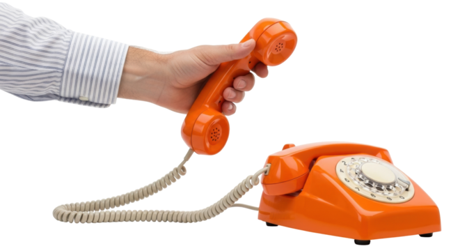 Isolated Orange rotary dial telephone, vintage desk phone with coiled cord, hand holding receiver