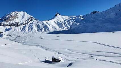 A stunning winter landscape on the Engstligenalp surrounded by deep white powder snow under a...