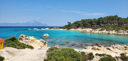 wild beach on the seashore. clean and soft sand, clear water and big stones. rest on the seashore or ocean. summer vacation or travel