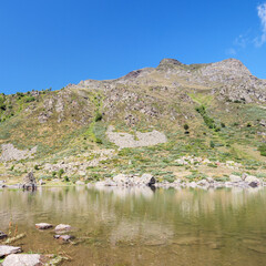 The rocky shore of Etang de Comte in the French Pyrenees