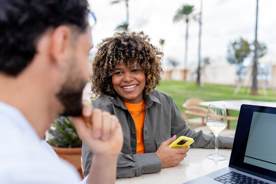 Diverse couple enjoying a date at outdoor cafe