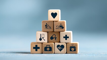 wooden blocks with medical icons stacked in a pyramid shape on a blue background, representing a health care concept.