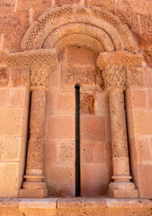 Detail of a 12th-13th century Romanesque apse window with carved columns on the former Church of San Miguel, Ayllón, Spain.