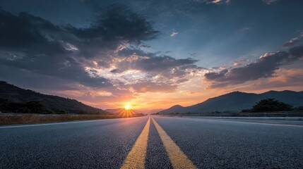 Majestic Sunset Over Open Road with Vivid Colors and Dramatic Clouds in Mountainous Landscape Perfect for Travel and Adventure Themes
