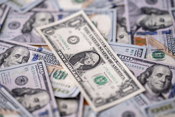 Money background with dollar bills. Texture of US dollars. 100 USD banknotes in focus. American hundred-dollars notes for banner. Pattern of US dollars for finance concept. Dollars currency.