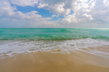 Relaxing seascape. Vacation shoreline. Luxury holiday resort. Light reflection on water. Coastal landscape. Turquoise lagoon. Golden sandy shore. Bright sunshine. Marine breeze. Tropical beach.