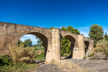 Magnificent Gothic Pont de Vilomara Bridge Barcelona Spain 14th Century Medieval Stone Arch Structure and Blue Sky