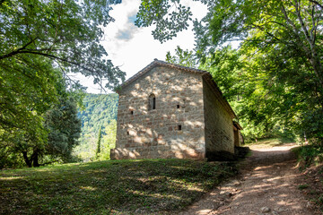 The ancient Romanesque hermitage of Sant Mart&iacute; del Corb nestled in a forest path in Les Preses. Catalonia, Spain.