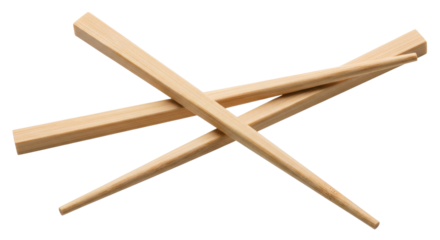 Isolated wooden chopsticks lying crossed on a surface, natural light reflecting from the wood