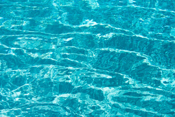 Ripped water in swimming pool. Surface of blue swimming pool, background of water.