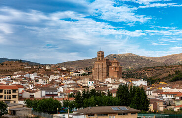 Obraz premium The historic village of Aniñón, crowned by its magnificent Mudejar church, nestled in the rolling hills of Aragon, Spain.