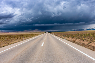 Journey through the Comarca de Campo de Gómara: An empty road leads into a dramatic storm in rural Spain.