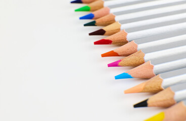 Sets of colored pencils placed neatly on a plain background