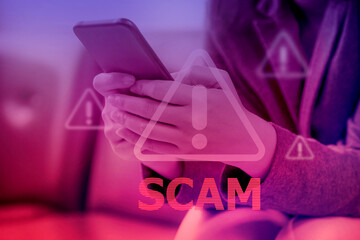 Hand using smartphone with scammer alert; Cyber security concept