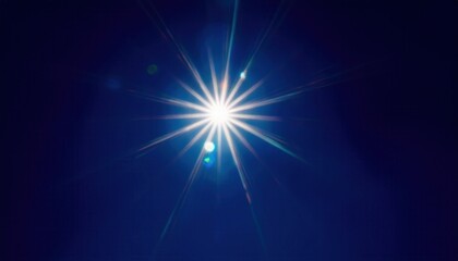 Obraz premium bright starburst light flare against deep blue night sky with radiant beams and lens glow creating cosmic abstract ethereal background ideal for expansive editorial banner or digital wallpaper