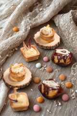 Assortment of sweet treats and candies on a textured surface